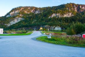 an empty road in front of a mountain at Strandheimen Guesthouse in Melhus +35 photos