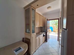 a kitchen with white cabinets and a table in it at Kallisti in Finikounta +7 photos
