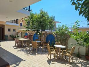 a patio with tables and chairs in a courtyard at Kallisti in Finikounta