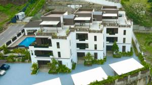 an aerial view of a white house with a swimming pool at Peev Apartments in Abuja