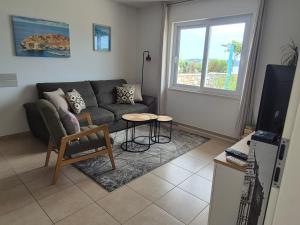 a living room with a couch and a table at Villa sea oasis Ratac in Slano