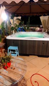 a hot tub with a table in front of it at Salento Houses & Idro Suites in Nardò