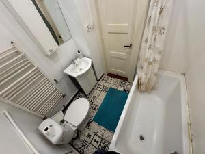 a small bathroom with a toilet and a sink at Pokoje Zbąszynek in Zbąszynek +18 photos