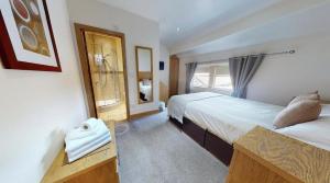 a hotel room with two beds and a window at The Horse & Farrier in Otley
