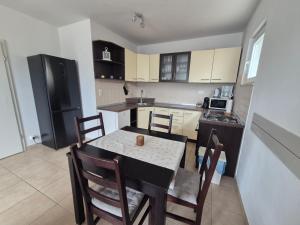 a kitchen with a table and chairs in a room at Villa sea oasis Ratac in Slano