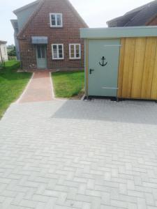 a garage with a door with an anchor on it at Haus Charlotte in Fehmarn