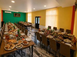 a long table with plates of food on it at Paceri in Itʼkhvisi