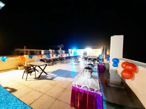 a group of tables and chairs on a stage with lights at DL Hotels & Resorts Corbett in Dhikuli +36 photos