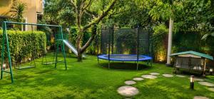 a playground with a trampoline in a yard at DL Hotels & Resorts Corbett in Dhikuli