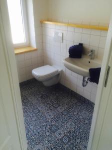 a bathroom with a toilet and a sink at Haus Charlotte in Fehmarn