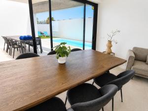 a dining room with a wooden table and chairs at Villa Drago in Antigua +8 photos