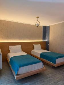 two beds in a room with two at Maganiskhedi in Mtskheta