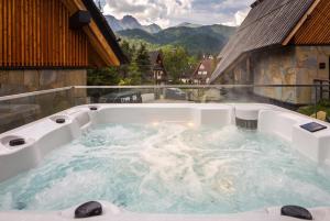 a jacuzzi tub on top of a building at come home - bespoke villa in Kościelisko