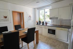 a kitchen with a wooden table and a dining room at IBS Wohnen in Windischeschenbach
