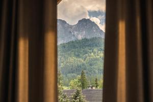 a view of a mountain from a window at come home - bespoke villa in Kościelisko +41 photos