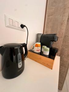 a coffee maker sitting on a counter next to a coffee pot at D&F Guest House in Milazzo