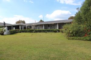 a building with a large yard in front of it at Kanyane @ Graskop in Graskop