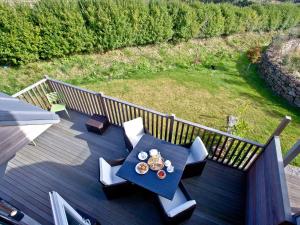 a table and chairs on a deck with a view at Una Aurum 56 in St Ives