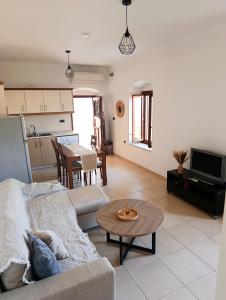 a living room with a couch and a table at Doukissa's Apartment in Symi