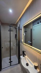 a bathroom with a shower and a sink and a mirror at The Bubble in Madrid