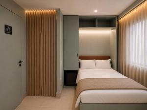 a bedroom with a bed and a large window at The Bubble in Madrid