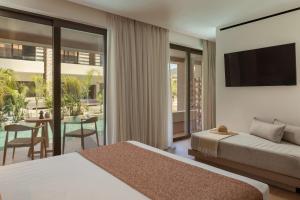 a hotel room with two beds and a television at LAN-GO SIVOTA Luxury Living in Syvota +157 photos