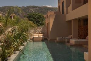 a swimming pool in the middle of a house at LAN-GO SIVOTA Luxury Living in Syvota