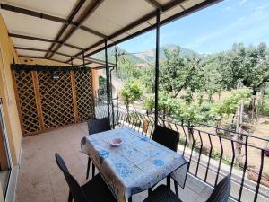a table and chairs on a balcony with a view at Biagio and Marias house in Trecchina