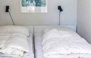 a bed with two pillows sitting next to each other at Lovely Home In Vordingborg With Wifi in Vordingborg