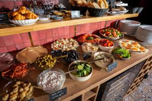 a buffet of different types of food on a table at Apart Neptun in Gdańsk