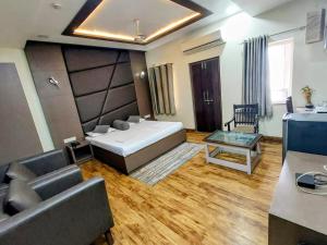 a living room with a couch and a table at Hotel Alka in Varanasi