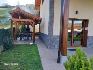 a wooden pergola on the side of a house at Argixti in Sumbilla