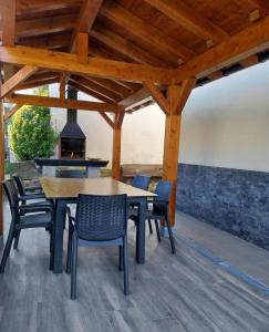 a patio with a table and chairs and a fireplace at Argixti in Sumbilla