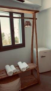 a room with a shelf with towels and a window at Almond Chambers in Naousa +53 photos