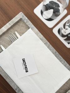 a white napkin sitting on top of a table at Almond Chambers in Naousa
