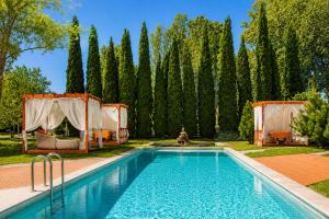 a swimming pool in a yard with trees at Sheraton Istanbul Atakoy Hotel in Istanbul
