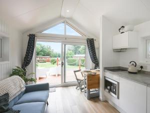 a kitchen and living room with a large window at Mini Lodge - Uk47682 in Montgomery