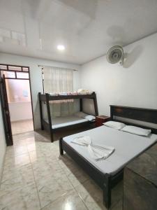 a room with two bunk beds and a couch at Villa Tania in Melgar
