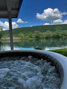 a jacuzzi tub with a view of a river at Holiday home Emma in Ripač