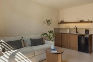 a living room with a couch and a kitchen at LAN-GO SIVOTA Luxury Living in Syvota