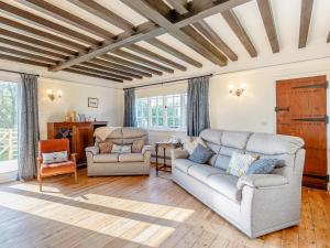 a living room with a couch and two chairs at Mark Farmhouse in Bradwell on Sea
