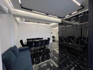 a barber shop with black chairs in a room at Hi-Tech Apartment in Tashkent +45 photos