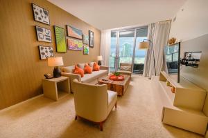 a living room with a couch and a table at Lyfe Resort Hollywood, Florida in Hollywood