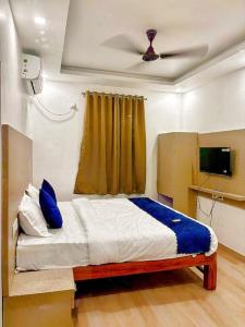 a bedroom with a bed with blue pillows on it at Baga Ocean Way in Baga
