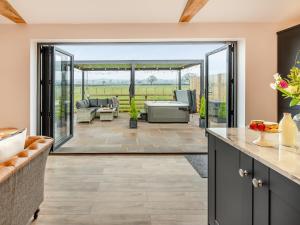 an open kitchen and living room with sliding glass doors at The Workshop - Uk42470 in Middleton