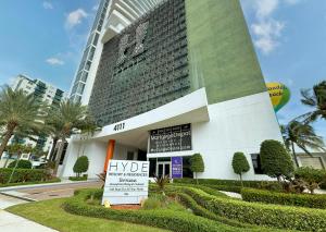 a large hotel with a sign in front of it at Lyfe Resort Hollywood, Florida in Hollywood