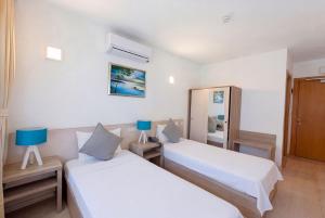 a room with two beds and a mirror at Aria Doria Otel in Datca +55 photos