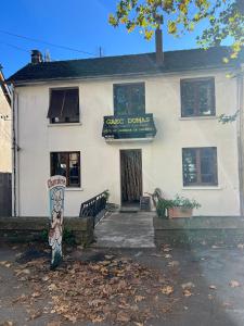a white building with a sign in front of it at Dumas St-Germain de calberte in Saint-Germain-de-Calberte