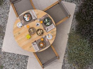an overhead view of a wooden table with food on it at Golden Milos Beach Ηouse by Domotel in Provatas