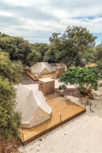 an overhead view of tents in a field with trees at Glamping Masseria Cuturi in Manduria +45 photos